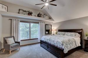 a bedroom with a bed and a chair and a window at Rural 6 bedroom cabin - With a Hot Tub! in Exeter