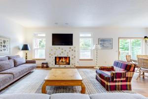 a living room with a couch and a fireplace at Beach Stroll Haven in Gearhart
