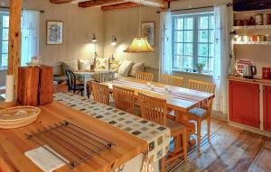 a kitchen and living room with a table and chairs at Lovely Home In Borlänge With Sauna in Borlänge