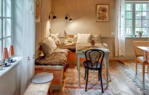 a living room with a table and a couch at Lovely Home In Borlänge With Sauna in Borlänge