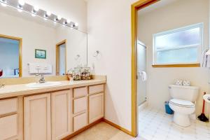 a bathroom with a sink and a toilet at Beach Stroll Haven in Gearhart +36 photos