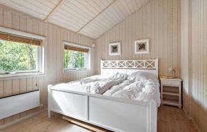 a white bed in a room with two windows at 2 Bedroom Gorgeous Home In Slagelse in Slagelse