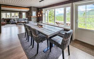 a dining room with a wooden table and chairs at 3 Bedroom Lovely Home In Skollenborg in Lindåskroken