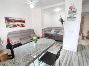 un piccolo soggiorno con tavolo e letto di Elegancia y Confort en Playa Jardín a Puerto de la Cruz