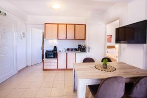 a kitchen and dining room with a table and chairs at Romanos Beach Villas in Romanu