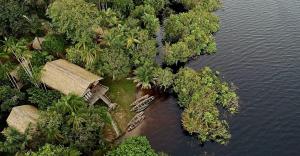 an aerial view of a tropical island with trees and water at Amazonas Life Camp in Manacapuru