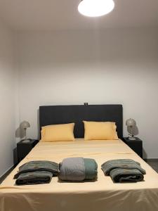 a bed with two pillows and towels on it at Anafis Exclusive in Athens +8 photos