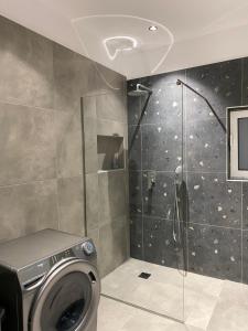 a washing machine in a bathroom with a shower at Anafis Exclusive in Athens