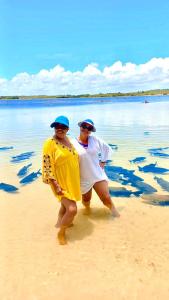 two people are standing on the beach at Casa Mar in Praia Da Caueira