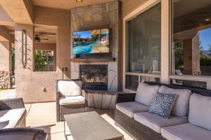 a living room with a couch and a fireplace at Casa Serenity - Luxury Living w Pool & Jacuzzi in Indio