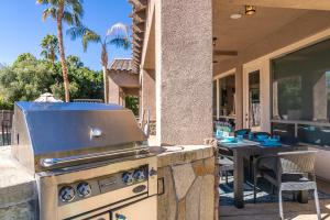 a grill on the patio of a house at Casa Serenity - Luxury Living w Pool & Jacuzzi in Indio