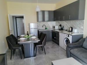 a kitchen and living room with a table and chairs at апартамент Богданов in Obzor