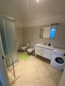 a bathroom with a sink and a washing machine at IL Passito Caluso in Caluso