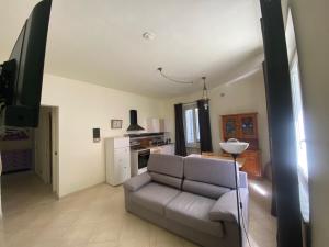 a living room with a couch and a television at IL Passito Caluso in Caluso