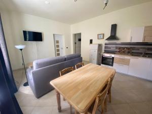 a living room with a couch and a table at IL Passito Caluso in Caluso +7 photos