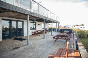 a deck with benches and tables on a building at 23 Chestnut Grove in Kirkcolm