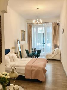a bedroom with a bed and a table with chairs at Hungaricum Budapest in Budapest