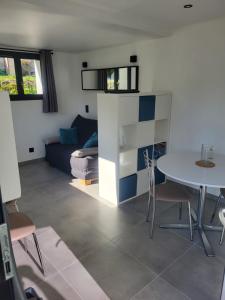 a living room with a table and a couch at Studio Saint Antoine Les Houches in Les Houches +13 photos