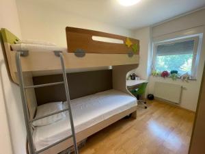 a bedroom with two bunk beds with a desk at Remi in Slavonski Brod