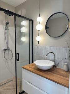 a bathroom with a sink and a mirror at Veronica Apartment in Sarandë