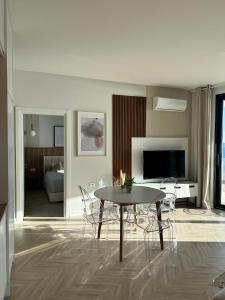 a living room with a table and chairs at Veronica Apartment in Sarandë