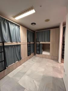 a room with curtains and a tiled floor at Hostel Sorolla Playa in Málaga