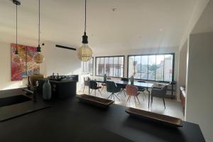 a kitchen and dining room with a table and chairs at Le Loft des Lumières in Château-Gontier
