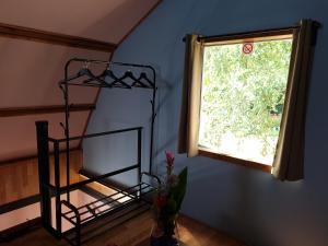 a blue room with a window and a vase with flowers at B&B voorne aan zee in Rockanje
