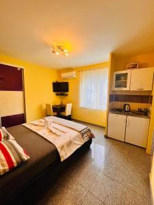 ein Schlafzimmer mit einem großen Bett und eine Küche in der Unterkunft Apartments Kristal in Kaštela