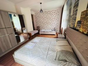 a bedroom with a large bed and a large window at Zuri Kvariati in Kvariati