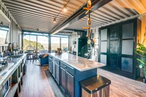 a kitchen with blue cabinets and a counter top at Fallbrook Airplane Home with Fire Pit and Mtn Views! in Temecula