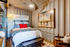 a bedroom with a bed with red pillows on it at Fallbrook Airplane Home with Fire Pit and Mtn Views! in Temecula