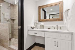 a white bathroom with a sink and a mirror at The Charter at Beaver Creek B135 in Beaver Creek