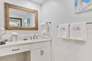 a bathroom with a sink and a mirror and towels at The Charter at Beaver Creek B135 in Beaver Creek