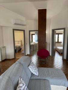 a living room with a couch and a bedroom at Theo House in Siena