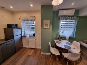a kitchen and dining room with a table and chairs at Apartament Megi in Kruszyn