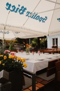 a table with a white table cloth and flowers on it at Bayerischer Hof Spalt in Spalt