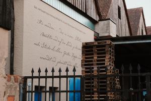 a wall with writing on the side of a building at Bayerischer Hof Spalt in Spalt