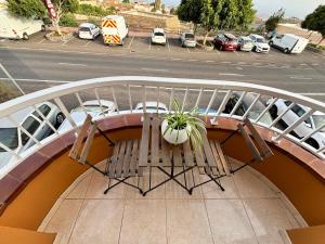 a bench on a balcony with a parking lot at Vista Montemar in San Miguel de Abona