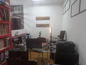 a room with a desk with a computer and chairs at luz Jujuy in San Salvador de Jujuy +2 photos