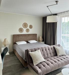 a bedroom with a bed and a couch at Aisa 39 in Pärnu