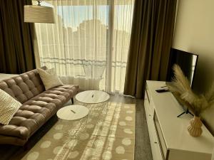 a living room with a couch and a large window at Aisa 39 in Pärnu