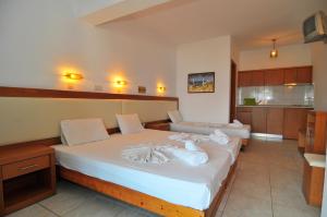 Postel nebo postele na pokoji v ubytování Hotel Emerald and Suites