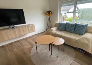 a living room with a couch and two tables at Ferienwohnung Bähr in Bornich