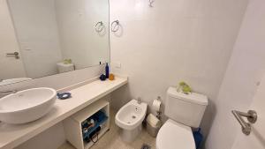 a white bathroom with a sink and a toilet at Magico Palermo in Buenos Aires +21 photos