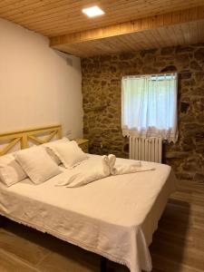 a large bed in a room with a window at LAR DE SUSA in Pontevedra
