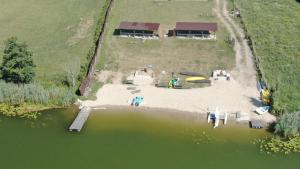 an aerial view of a house next to a lake at Nad Sunowem Lake House in Chrzanowo