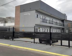 a building with a bus parked in front of it at LOFT3 COMPLETO AR CANAIS ASSINAT GARAGEM INTERNET Prox Aparecida e Industrias in Pindamonhangaba