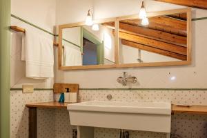 a bathroom with a sink and a mirror at La campagna e il mare in Catania +19 photos