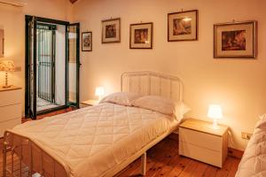a bedroom with a large bed and two lamps at La campagna e il mare in Catania